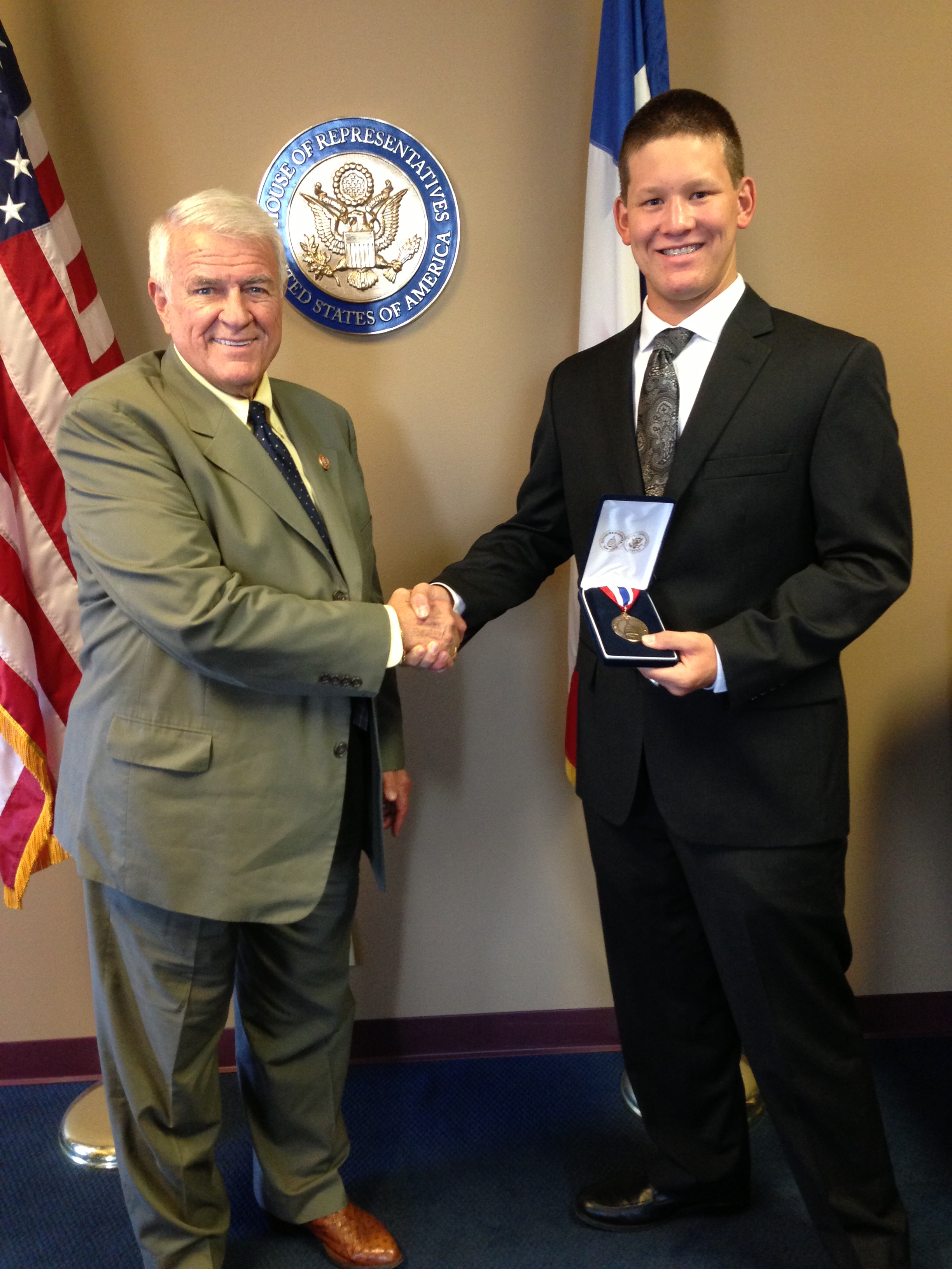 Travis Purser recieves his award from Congressman Carter